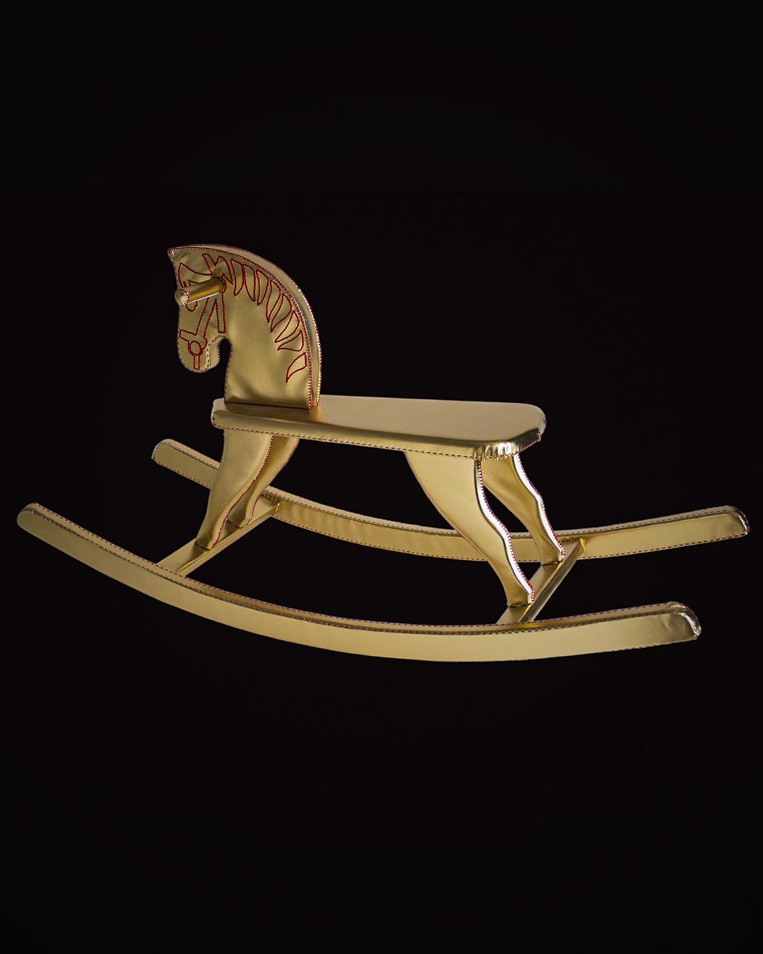 In Fabula — golden rocking horse